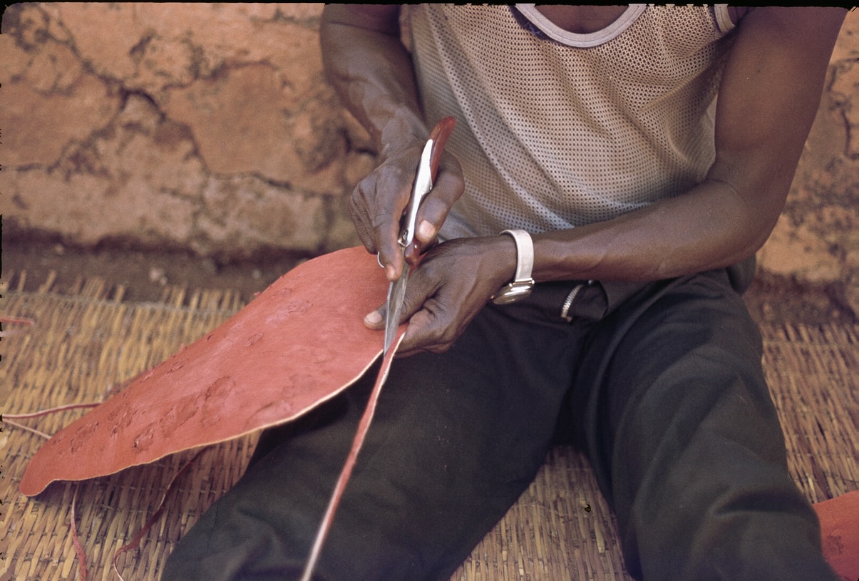 cutting tanned goat skin